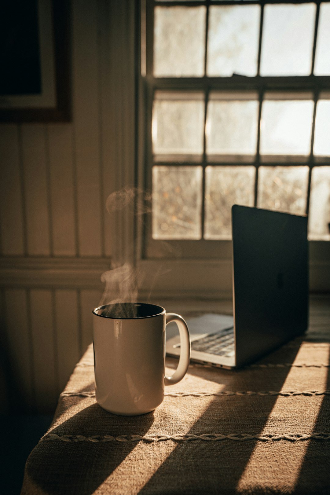 Laptop showing a news website on a desk