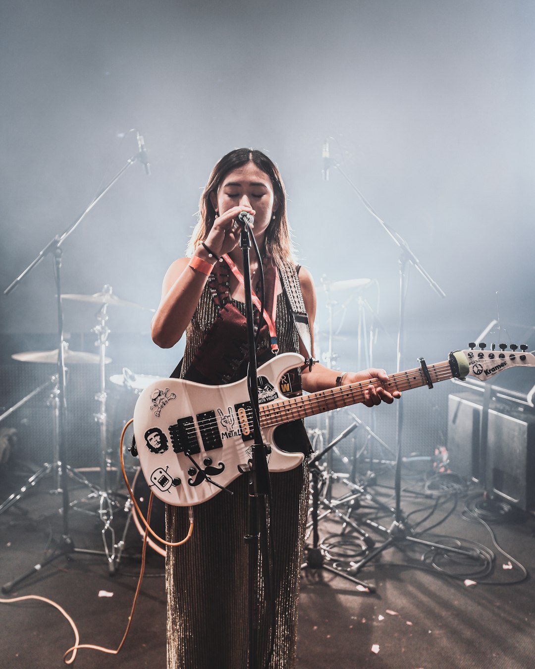 musician playing guitar on stage