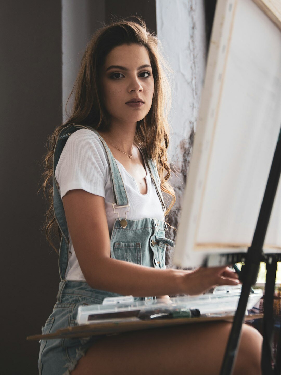 female artist painting on canvas